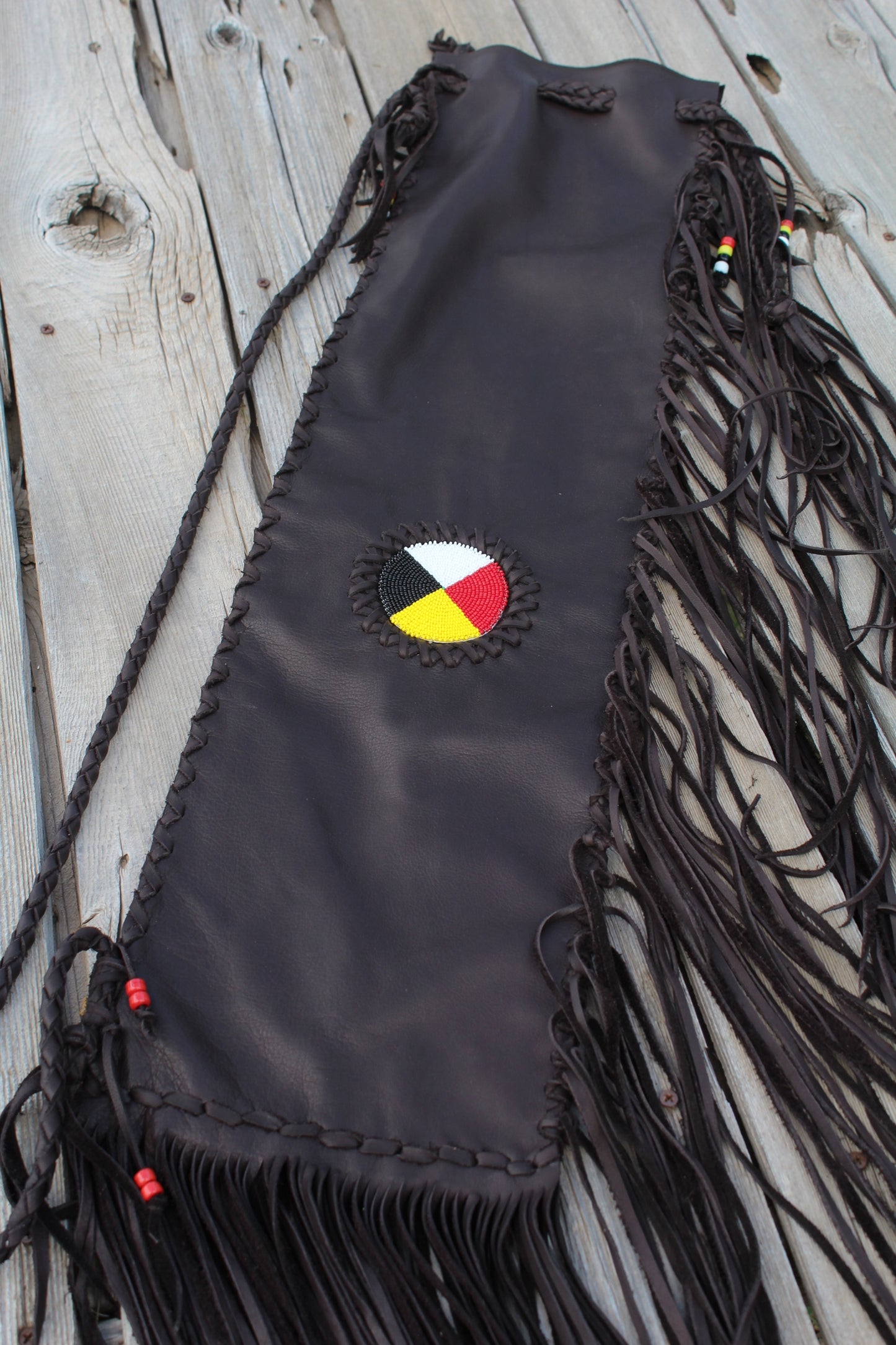 Fringed leather flute bag with beaded medicine wheel