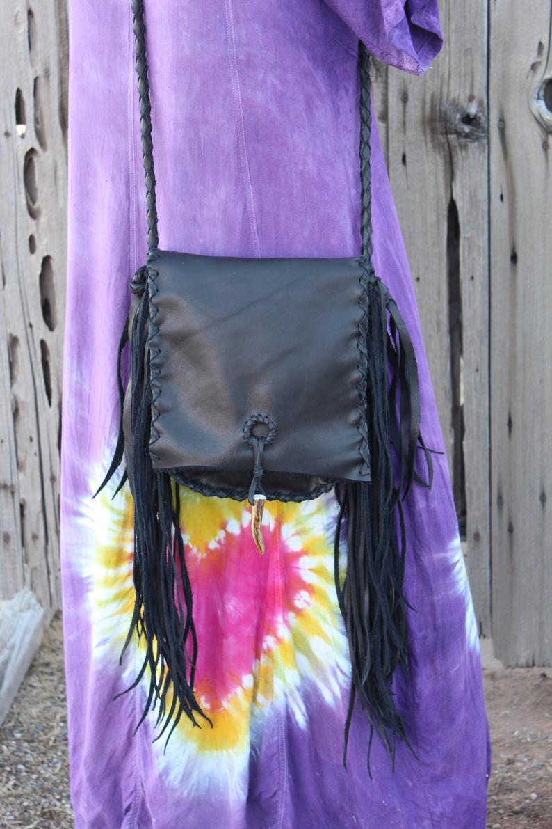 Black leather handbag with fringe and an antler tip closure