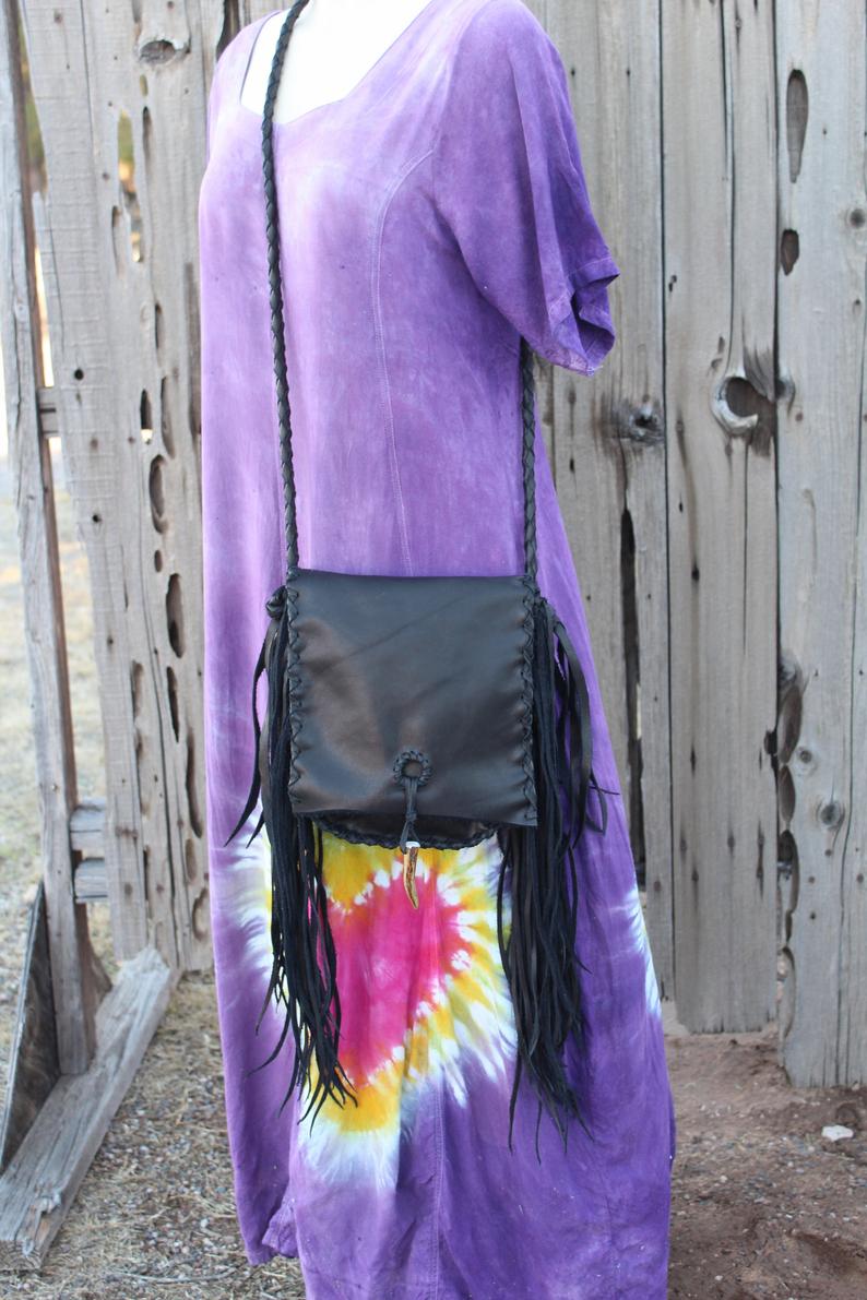 Black leather handbag with fringe and an antler tip closure