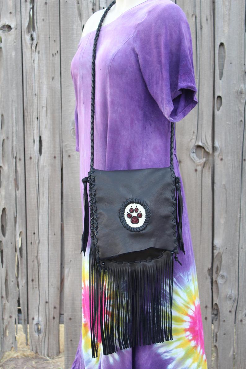 Black fringed handbag, beaded wolf paw design