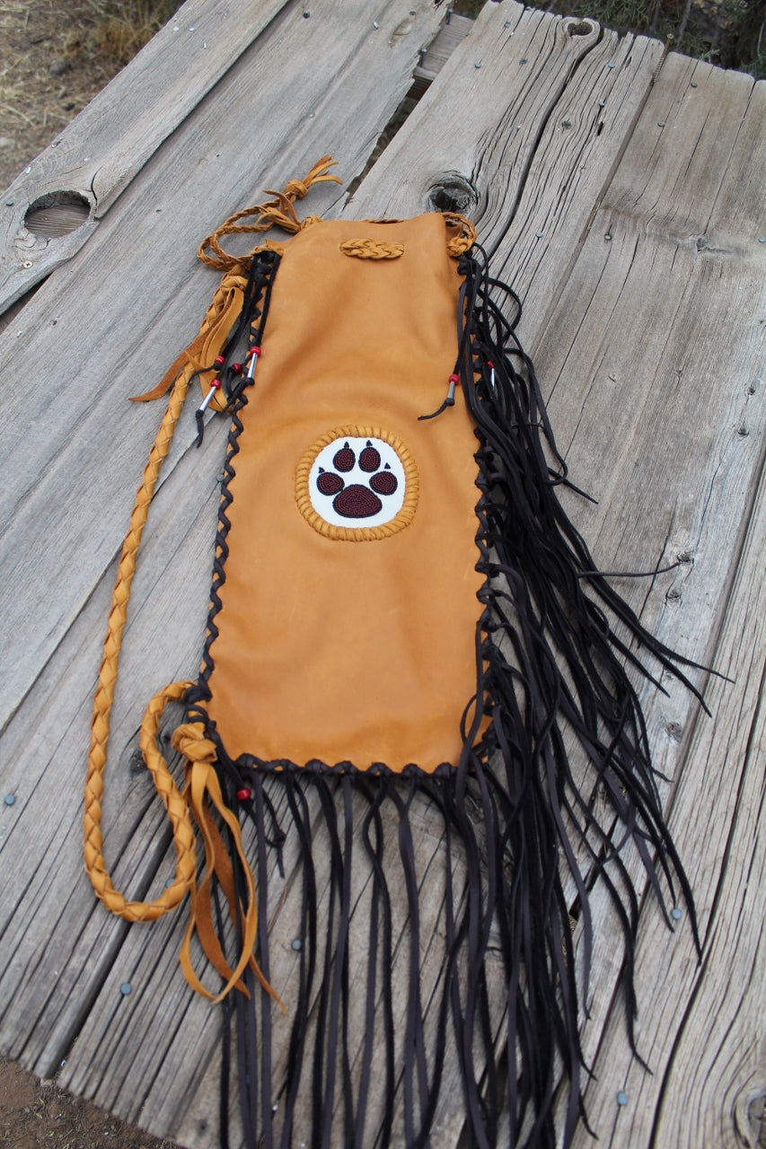 Fringed pipe bag with a beaded wolf paw, chanupa bag