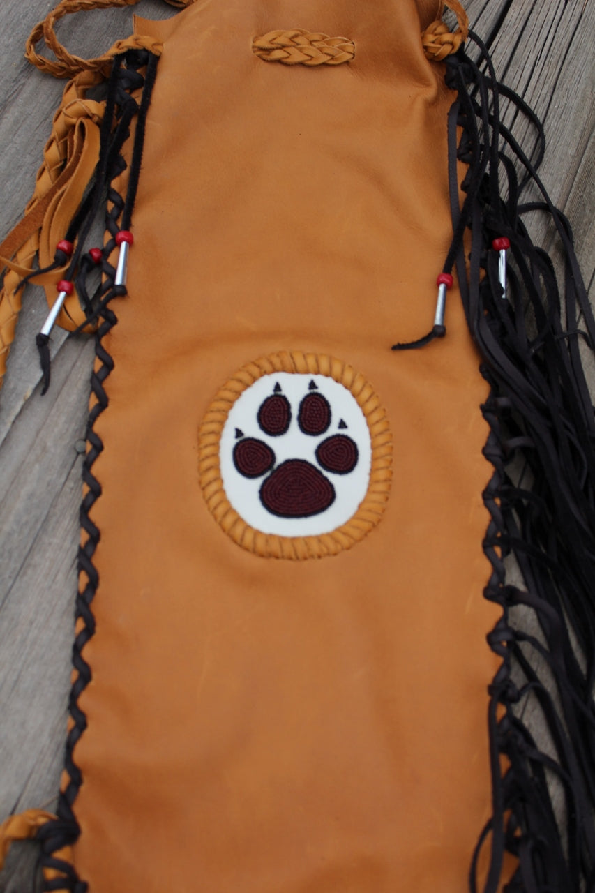 Fringed pipe bag with a beaded wolf paw, chanupa bag