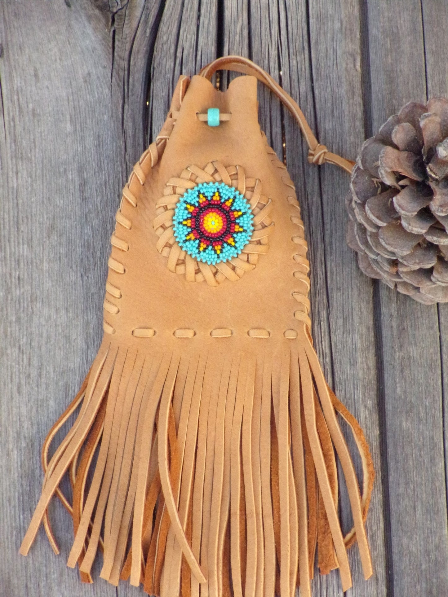 Fringed leather amulet bag, sunflower beadwork