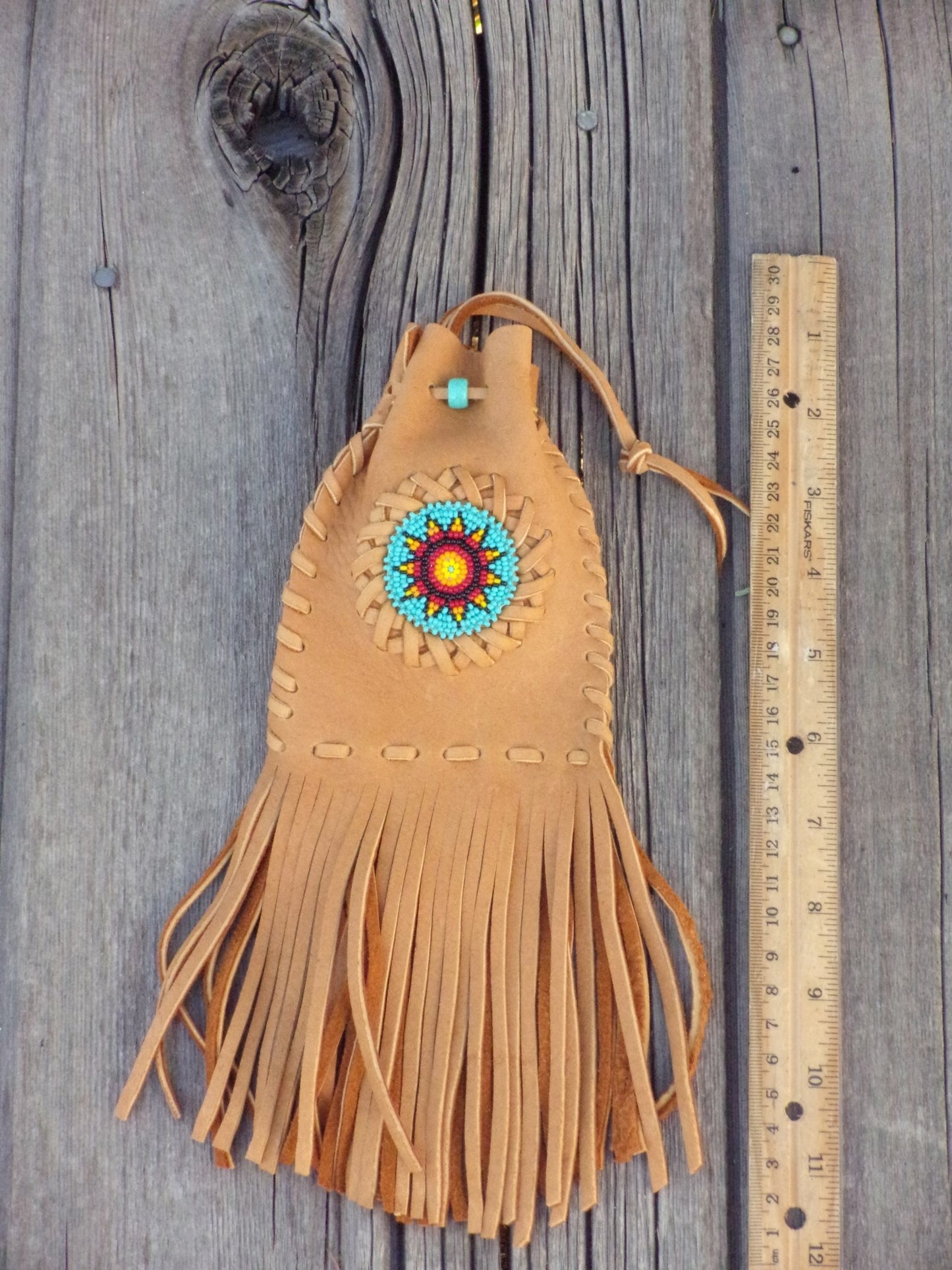 Fringed leather amulet bag, sunflower beadwork