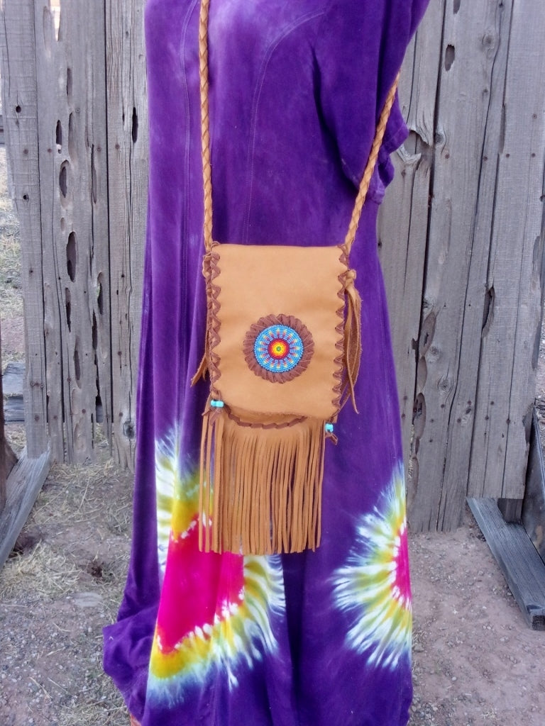 Fringed leather handbag with a beaded starburst rosette design , custom designed