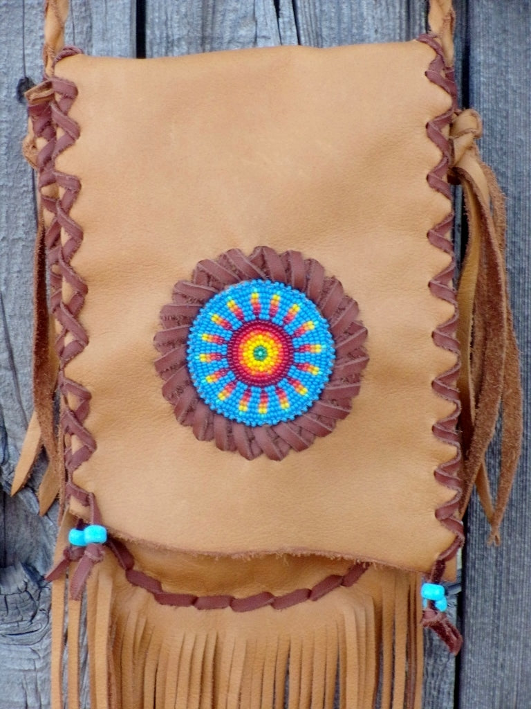 Fringed leather handbag with a beaded starburst rosette design , custom designed