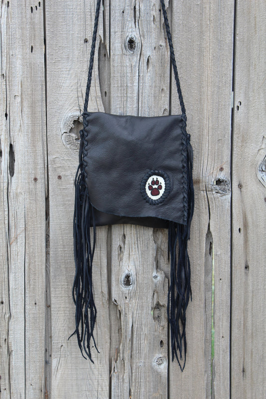 Black leather fringed handbag, beaded wolf paw design