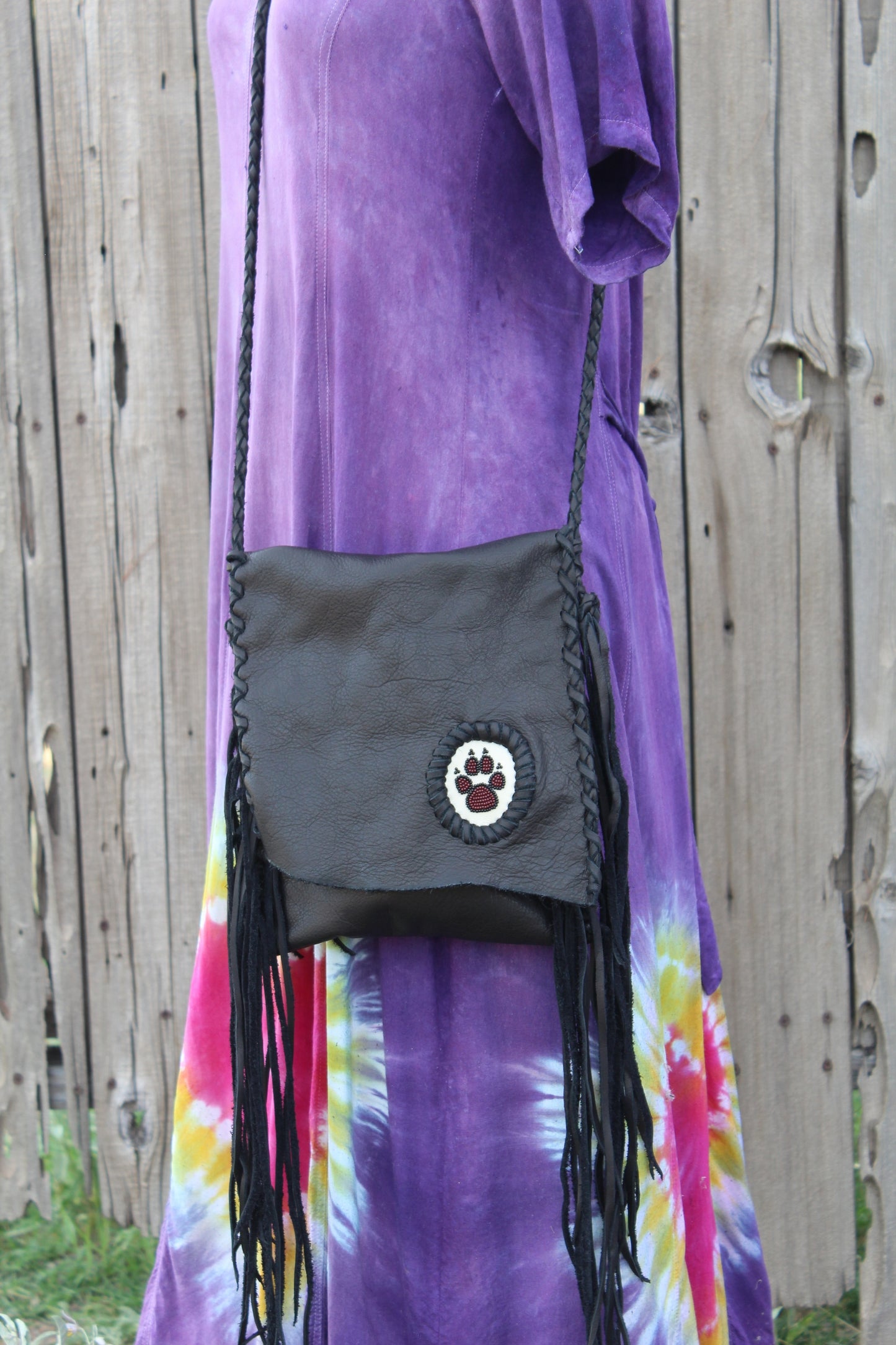 Black leather fringed handbag, beaded wolf paw design