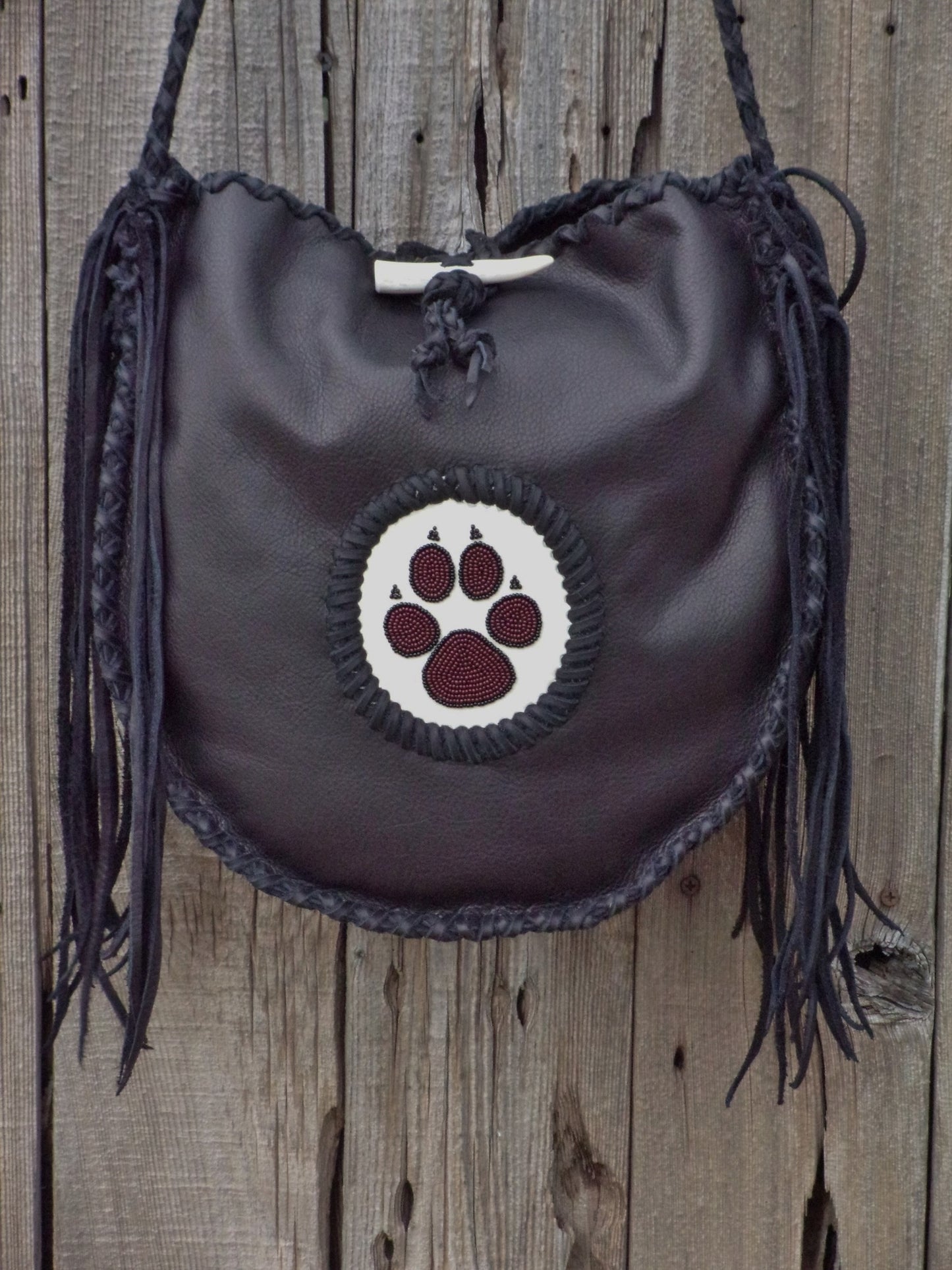 Black leather tote with wolf paw totem