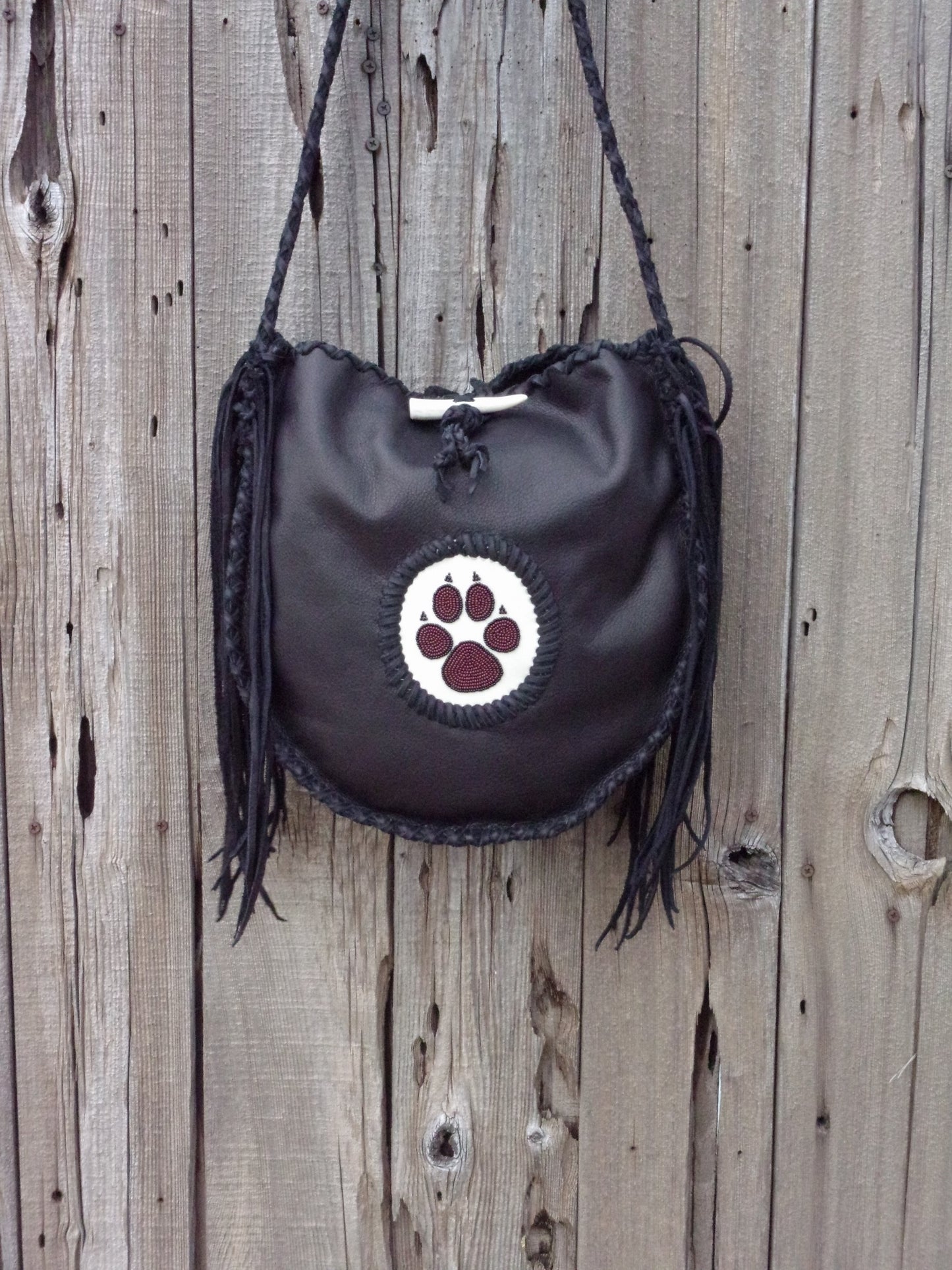 Black leather tote with wolf paw totem