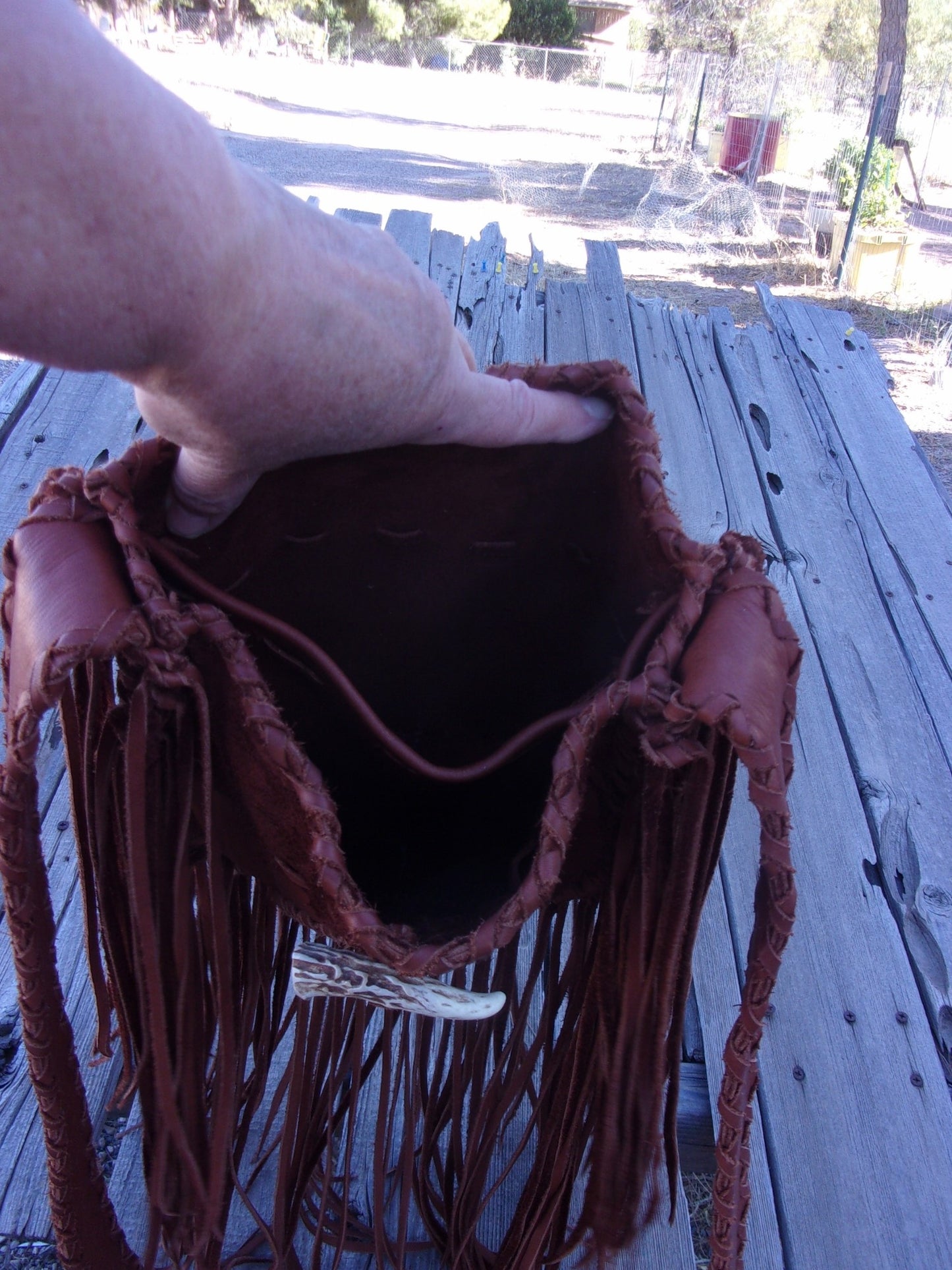 Fringed leather tote with beaded turtle