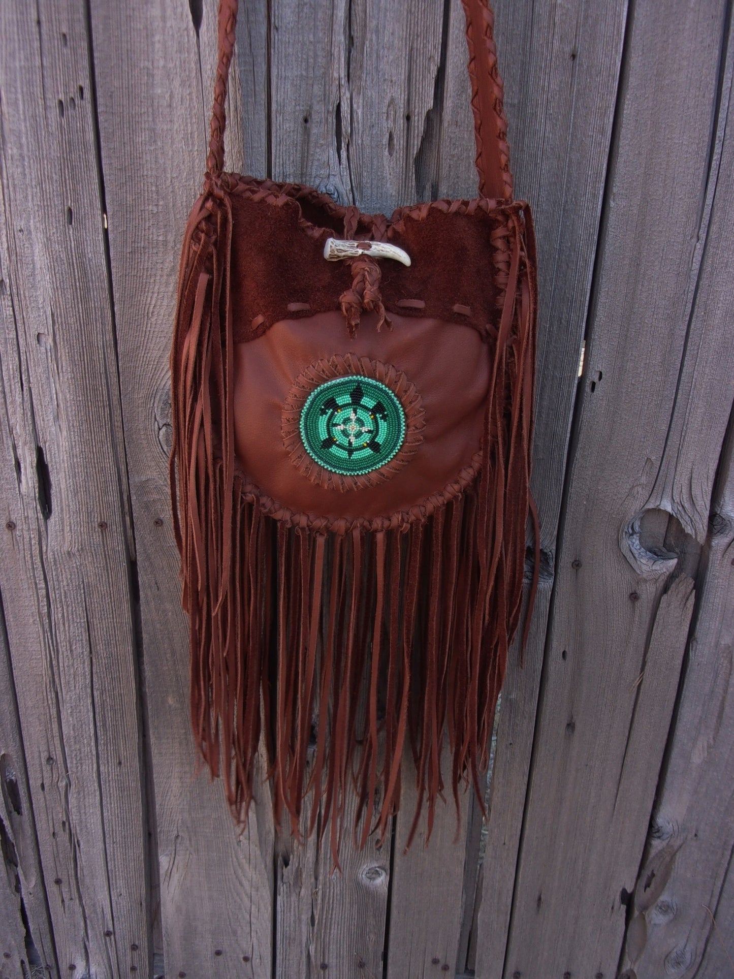 Fringed leather tote with beaded turtle