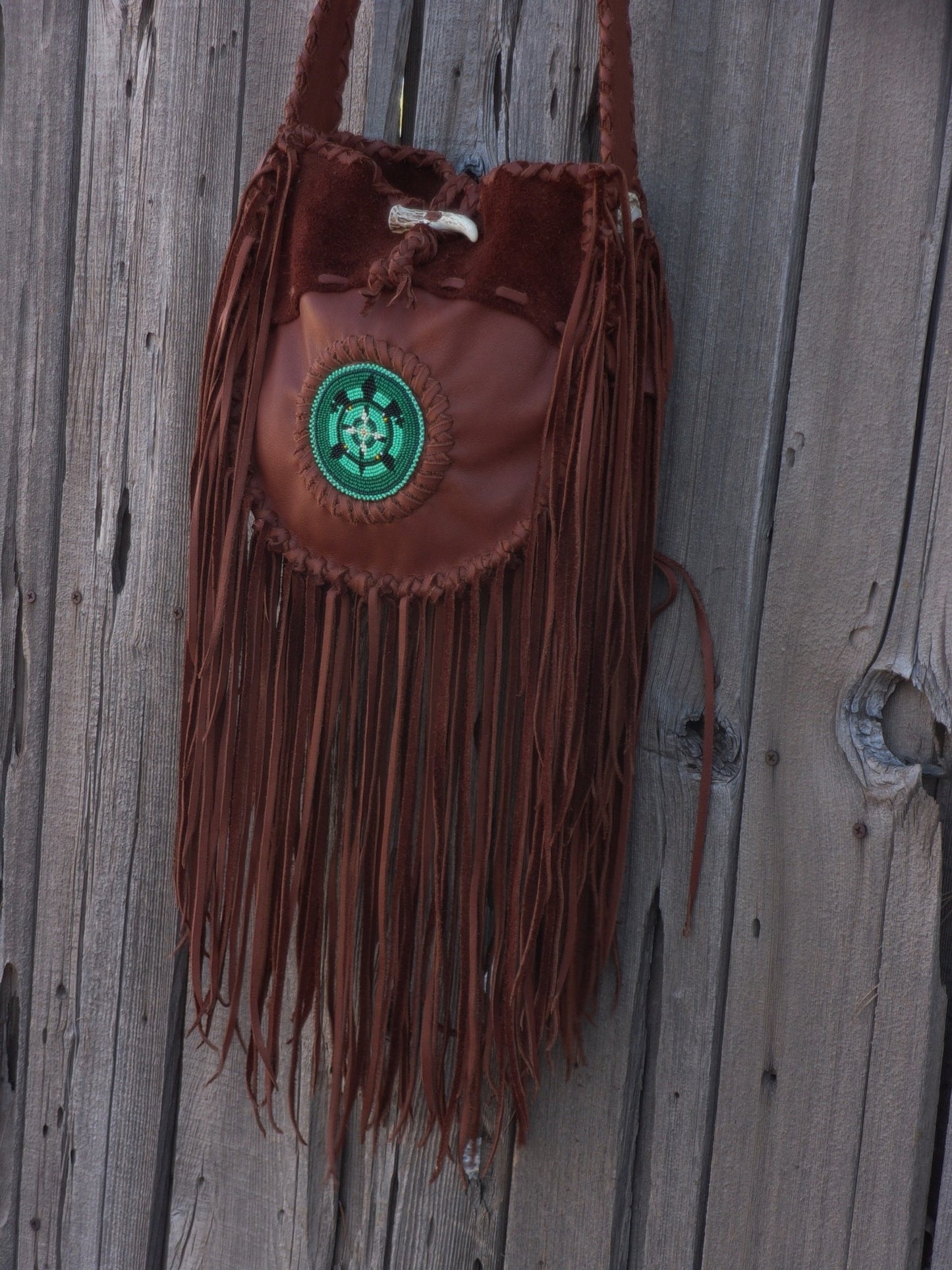 Fringed leather tote with beaded turtle