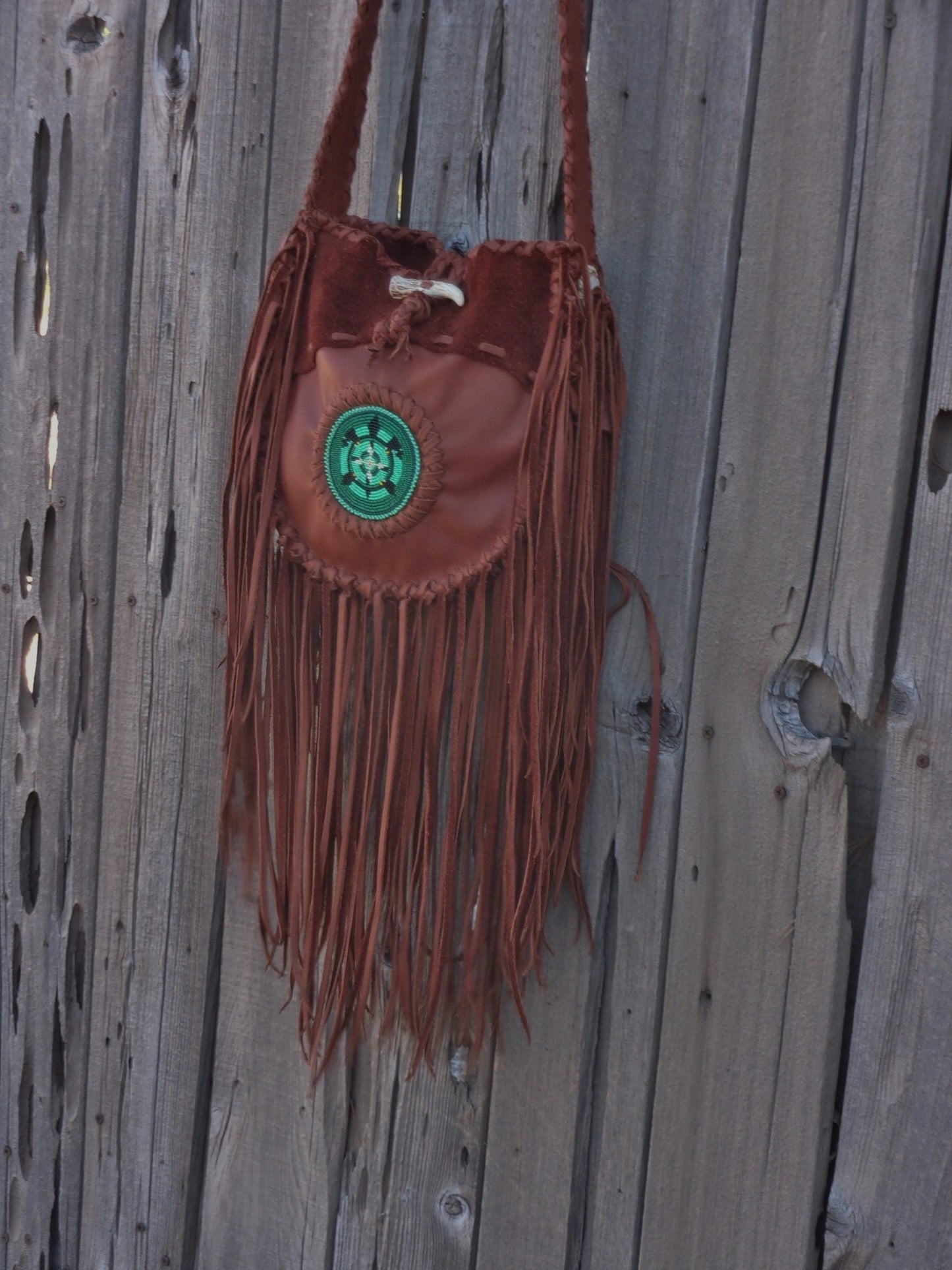 Fringed leather tote with beaded turtle