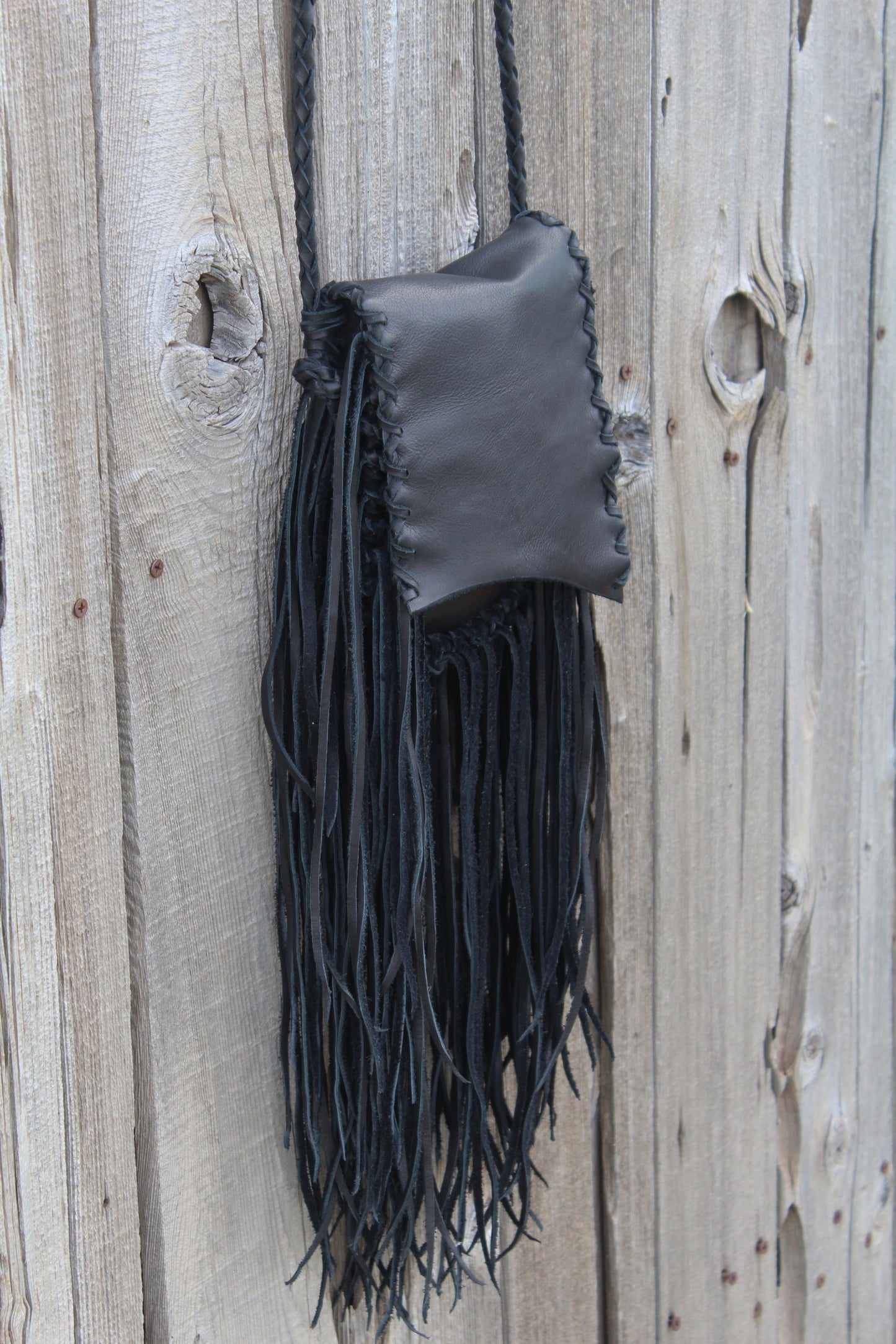 Black leather handbag with fringe, crossbody bag