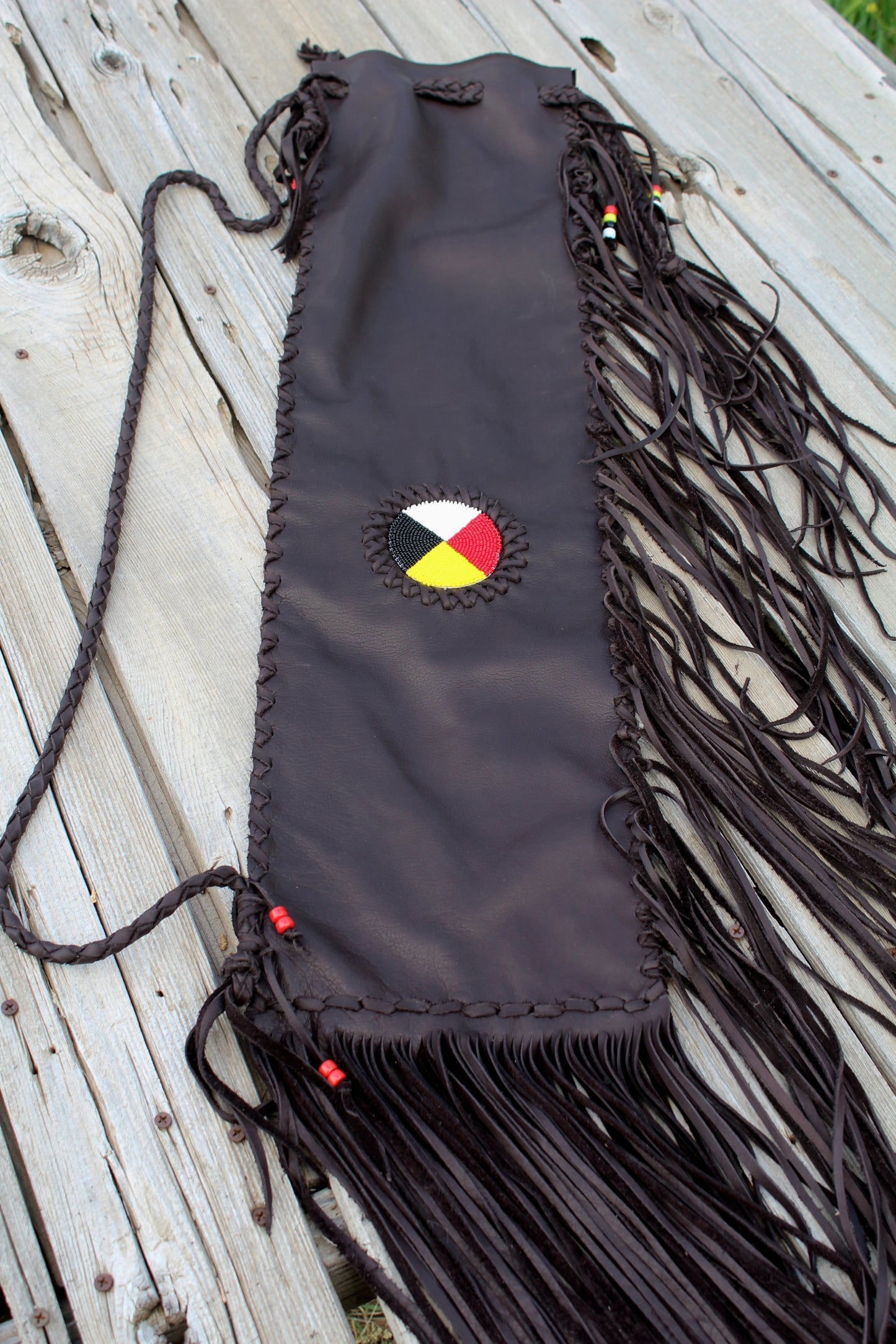 Fringed leather flute bag with beaded medicine wheel