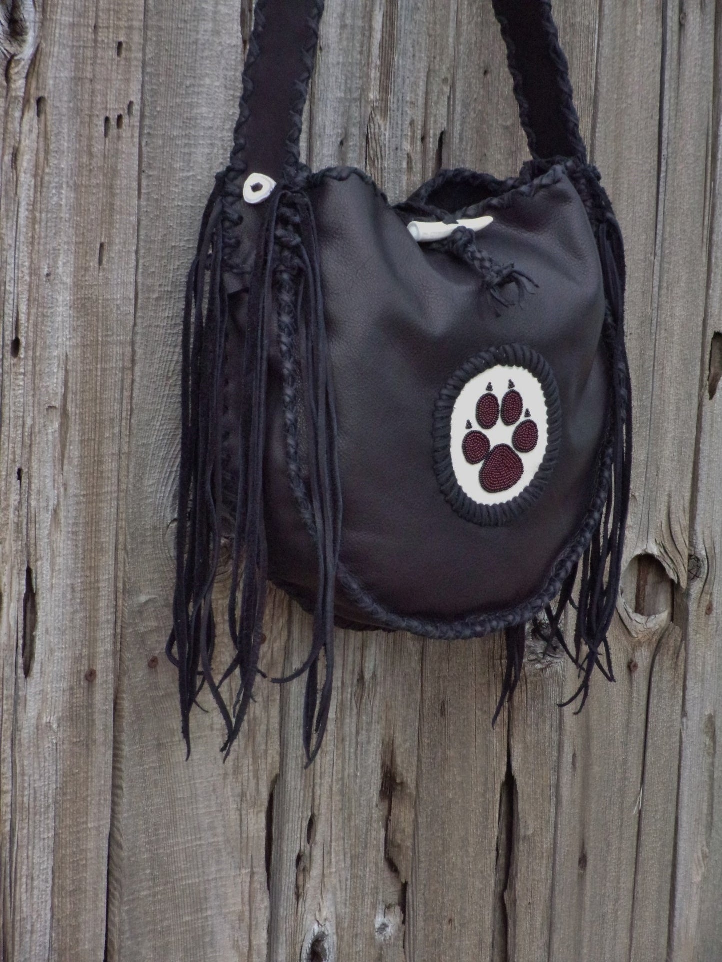 Black leather tote with wolf paw totem