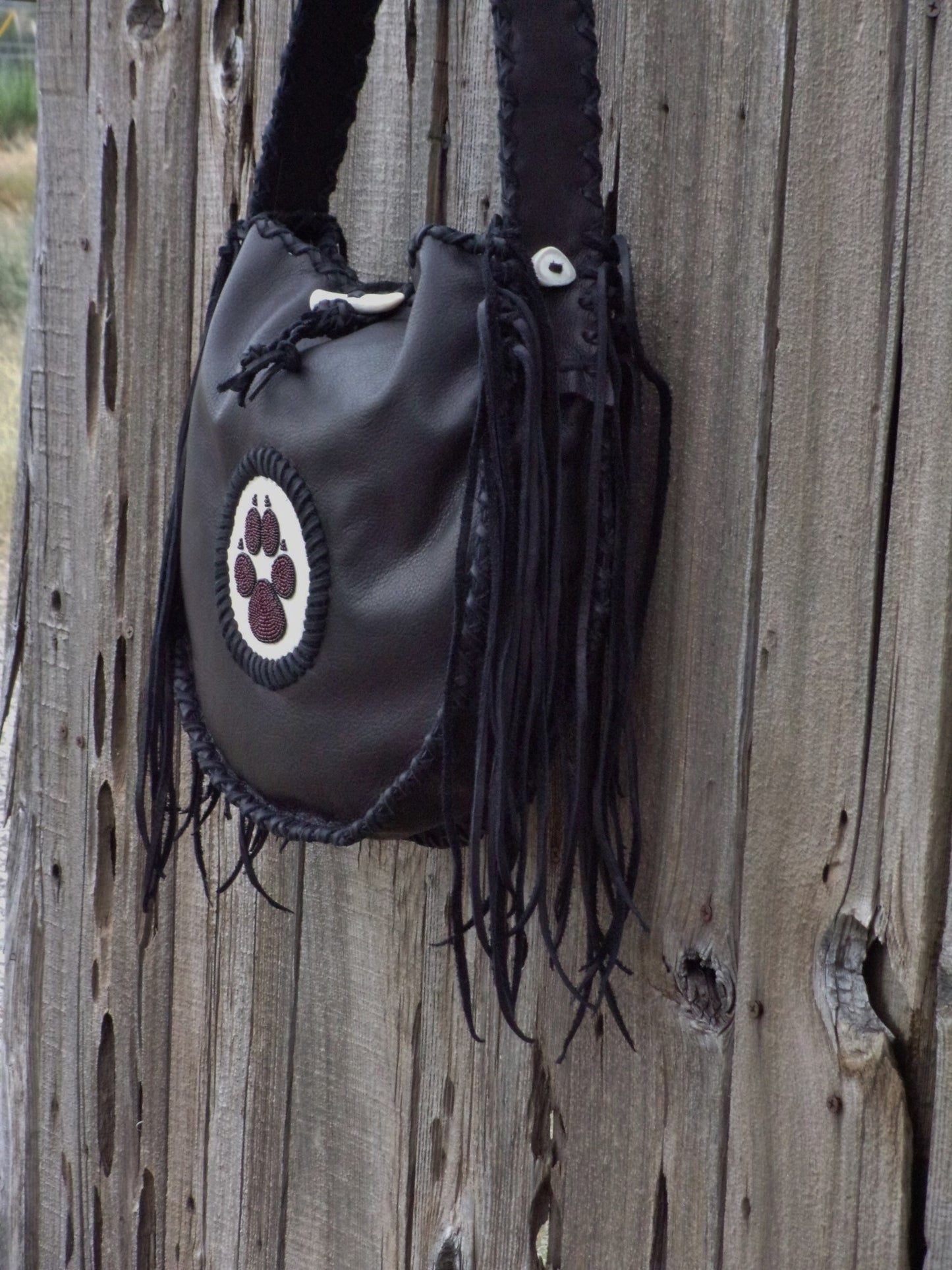 Black leather tote with wolf paw totem